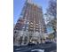 Museum Tower condo building with a mix of red brick and concrete, featuring balconies and a prominent entrance at 285 Centennial Olympic Park Dr # Ph 1-4, Atlanta, GA 30313