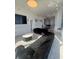 Spacious living room with a tufted sofa, a flat screen tv and city views with an adjacent dining area at 285 Centennial Olympic Park Dr # Ph 1-4, Atlanta, GA 30313