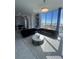 Bright living room with city views, a modern coffee table, tile flooring and stylish grey striped rug at 285 Centennial Olympic Park Dr # Ph 1-4, Atlanta, GA 30313
