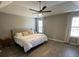 Spacious bedroom with tray ceiling, ceiling fan, and large windows allowing ample natural light at 2895 Dominion Walk Ln, Snellville, GA 30078