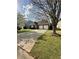 Traditional-style home with a long driveway and a neatly maintained lawn at 2895 Dominion Walk Ln, Snellville, GA 30078