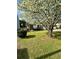 Well-kept front yard with a large tree and blooming flowers in a residential neighborhood at 2895 Dominion Walk Ln, Snellville, GA 30078