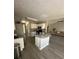 Open-concept kitchen with an island, granite countertops, stainless steel appliances, and hardwood floors at 2895 Dominion Walk Ln, Snellville, GA 30078
