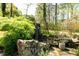 Secluded backyard garden with stone accents and diverse greenery at 4449 Lashley Dr, Tucker, GA 30084