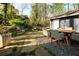 Backyard patio featuring an outdoor dining set and stone pathway at 4449 Lashley Dr, Tucker, GA 30084