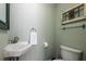 Half-bathroom with white sink, toilet and decorative accents at 4449 Lashley Dr, Tucker, GA 30084