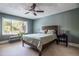 Cozy bedroom features a comfortable bed, a ceiling fan, and a bright window view at 4449 Lashley Dr, Tucker, GA 30084
