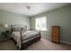 Cozy bedroom with a metal frame bed, neutral colored walls, and a bright window at 4449 Lashley Dr, Tucker, GA 30084