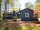 Charming exterior view of home with mature trees, blue paint, and a chimney at 4449 Lashley Dr, Tucker, GA 30084