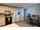 Traditional kitchen with white cabinets, gray floors and black appliances at 4449 Lashley Dr, Tucker, GA 30084