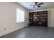 Living room featuring a large bookcase, ceiling fan, and bright window at 4449 Lashley Dr, Tucker, GA 30084