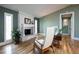 Living room view features hardwood floors, a white painted brick fireplace, and bright windows at 4449 Lashley Dr, Tucker, GA 30084