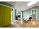 Bright living space with hardwood floors, fireplace, and yellow front door at 4449 Lashley Dr, Tucker, GA 30084