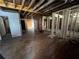 Spacious living room awaiting renovation, showcasing exposed wooden beams and an open layout at 852 Laurelmont Dr, Atlanta, GA 30311