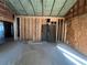 View of a partially renovated living room with exposed beams and concrete floors at 852 Laurelmont Dr, Atlanta, GA 30311