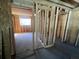 Partially renovated living room with new framing, flooring, and large windows at 852 Laurelmont Dr, Atlanta, GA 30311