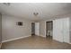 This is a bedroom with tile flooring, a tv wall mount, and two doors at 10104 Fairington Ridge Cir, Lithonia, GA 30038