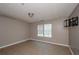 This is a bedroom with tile flooring, a window, and a tv wall mount at 10104 Fairington Ridge Cir, Lithonia, GA 30038