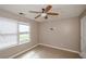 Bedroom featuring a ceiling fan, window, and tile floors at 10104 Fairington Ridge Cir, Lithonia, GA 30038