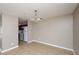 Cozy dining area adjacent to the kitchen, featuring tile flooring and a stylish chandelier at 10104 Fairington Ridge Cir, Lithonia, GA 30038