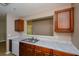 This kitchen features wooden cabinets, white countertops, and a stainless steel sink at 10104 Fairington Ridge Cir, Lithonia, GA 30038