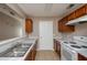 Functional kitchen featuring a double sink, white appliances, and ample cabinet space at 10104 Fairington Ridge Cir, Lithonia, GA 30038