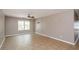 Bright living room featuring tile flooring, neutral walls, a ceiling fan, and a large window at 10104 Fairington Ridge Cir, Lithonia, GA 30038