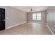 Spacious living room features tile floors, a ceiling fan, and a large window providing natural light at 10104 Fairington Ridge Cir, Lithonia, GA 30038