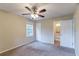 Bedroom featuring a ceiling fan, window, and doorway leading to bathroom at 3891 Northstrand Dr, Decatur, GA 30035