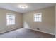 Inviting bedroom featuring two windows, plush carpet, and natural light at 3891 Northstrand Dr, Decatur, GA 30035