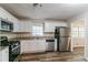 Well-lit kitchen featuring white cabinets, stainless steel appliances, and granite countertops at 3891 Northstrand Dr, Decatur, GA 30035