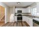 Modern kitchen with stainless steel appliances, white cabinets, and granite countertops at 3891 Northstrand Dr, Decatur, GA 30035