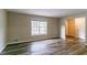 Spacious living room with wood-look floors and neutral wall color at 3891 Northstrand Dr, Decatur, GA 30035
