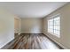 Bright living room with wood-look floors and a large window at 3891 Northstrand Dr, Decatur, GA 30035