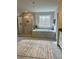 Modern bathroom featuring a glass-enclosed shower, a soaking tub, and neutral tile at 7580 Sunridge Ln, Douglasville, GA 30135