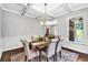 Formal dining room featuring wainscoting, a coffered ceiling, and a classic chandelier above the dining table at 7580 Sunridge Ln, Douglasville, GA 30135