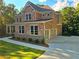 Elegant brick residence features a two-car garage and a well-manicured lawn and driveway at 7580 Sunridge Ln, Douglasville, GA 30135