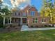 Stunning two-story brick home features a welcoming front porch and manicured lawn at 7580 Sunridge Ln, Douglasville, GA 30135