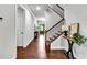 Elegant foyer with hardwood floors, staircase, and stylish console table creates a welcoming entrance at 7580 Sunridge Ln, Douglasville, GA 30135