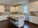 Spacious kitchen boasting stainless steel appliances, white cabinetry, and a granite-topped island at 7580 Sunridge Ln, Douglasville, GA 30135