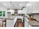 Modern kitchen with granite counters, an island with seating, and stainless steel appliances at 7580 Sunridge Ln, Douglasville, GA 30135