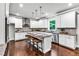 Spacious kitchen with a central island, bar stool seating, and stainless steel appliances at 7580 Sunridge Ln, Douglasville, GA 30135