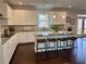 Modern kitchen with white cabinets, granite countertops, stainless steel appliances, and a central island at 7580 Sunridge Ln, Douglasville, GA 30135