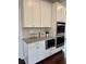 Modern kitchen with built-in microwave and double ovens, complemented by granite countertops at 7580 Sunridge Ln, Douglasville, GA 30135
