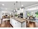 Open-concept kitchen featuring an island with granite counters, stainless steel appliances and hardwood floors at 7580 Sunridge Ln, Douglasville, GA 30135