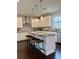 Well-lit kitchen featuring stainless steel appliances, white cabinets, and a central island with bar stools at 7580 Sunridge Ln, Douglasville, GA 30135