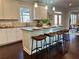 Elegant kitchen with white cabinetry, granite island with bar stools, and stainless steel appliances at 7580 Sunridge Ln, Douglasville, GA 30135