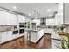 Bright, modern kitchen with white cabinets, granite countertops, an island, and stainless steel appliances at 7580 Sunridge Ln, Douglasville, GA 30135