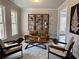 Stylish living room features modern furniture, a decorative bookshelf, and an eye-catching art piece at 7580 Sunridge Ln, Douglasville, GA 30135
