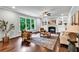 Cozy living room with hardwood floors, large windows, and a fireplace with built-in shelving at 7580 Sunridge Ln, Douglasville, GA 30135